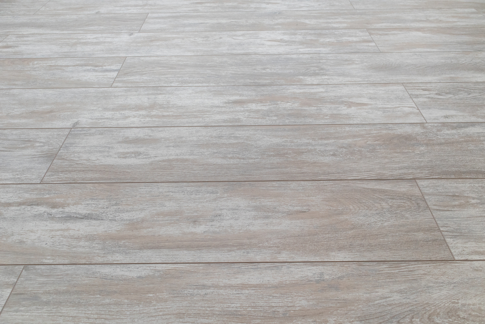 overview of installed gray vinyl plank flooring.
