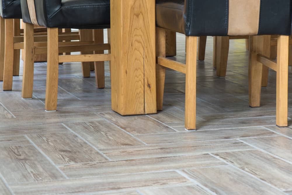 tile flooring in wood pattern installed in dining room.
